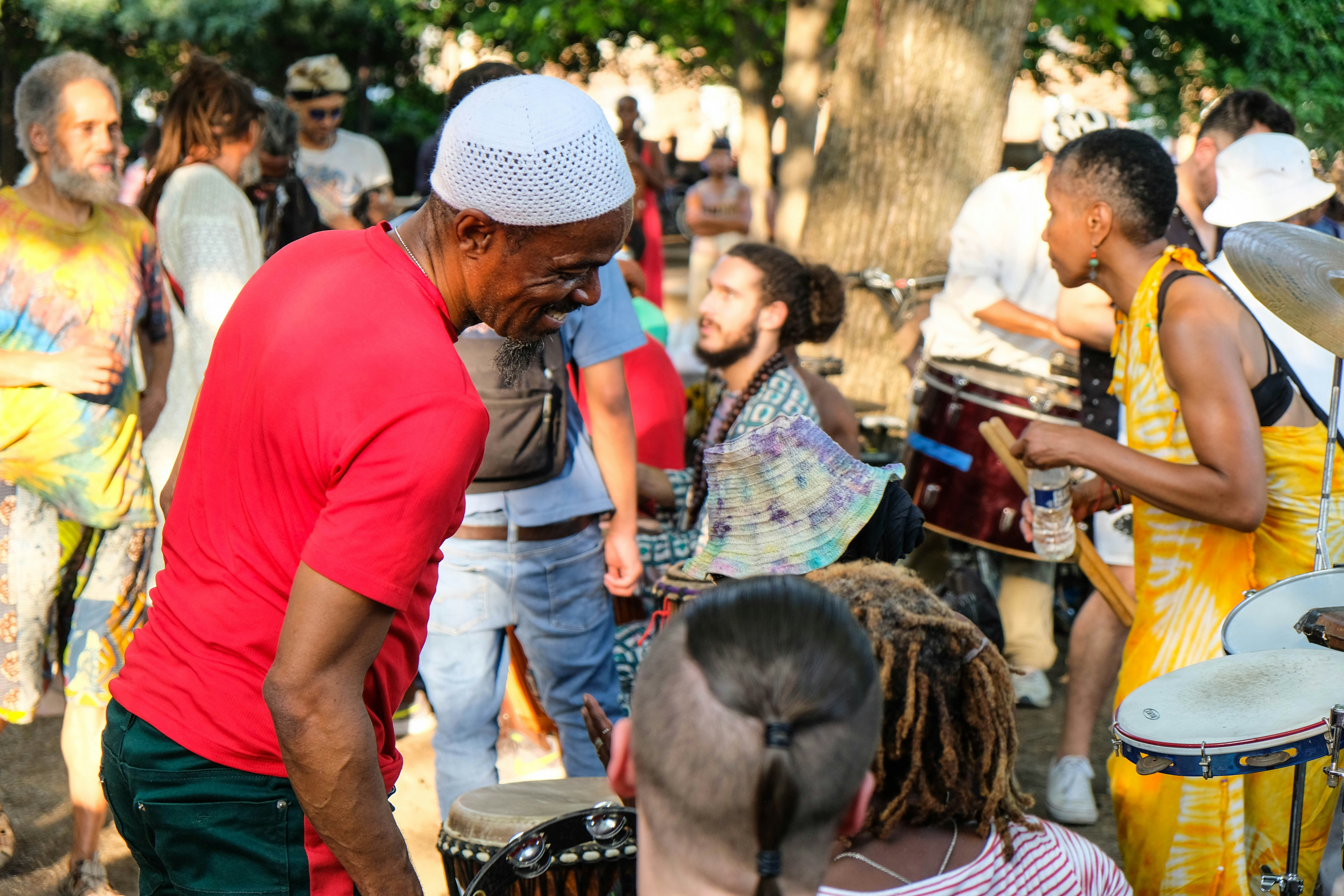 Man in red shirt in front of people with instruments