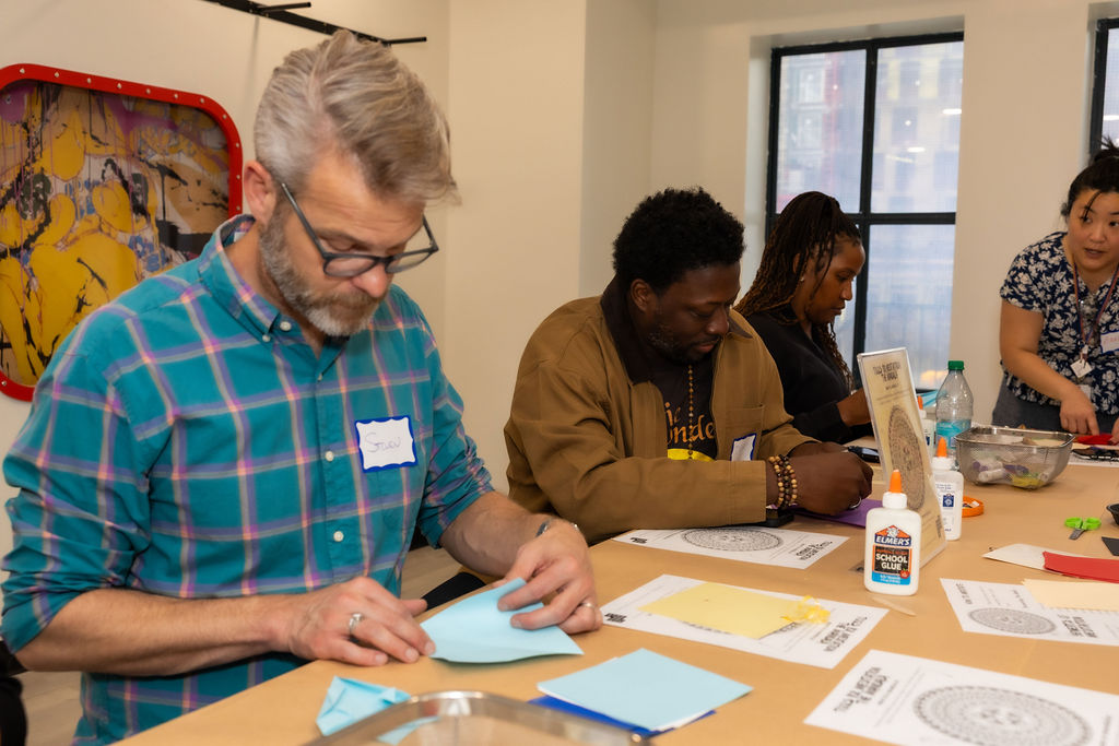 People inside of a class working on arts and crafts