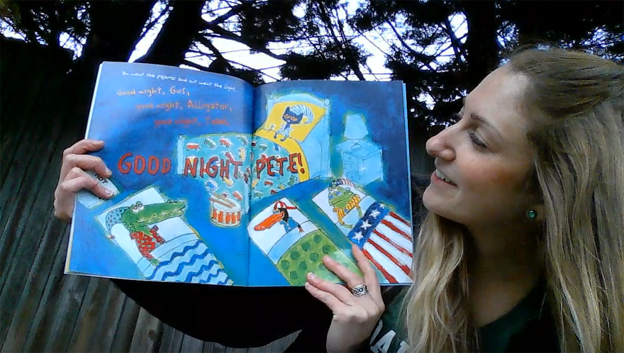 Photo of a blonde woman looking at the inner pages of a "Pete the Cat" book